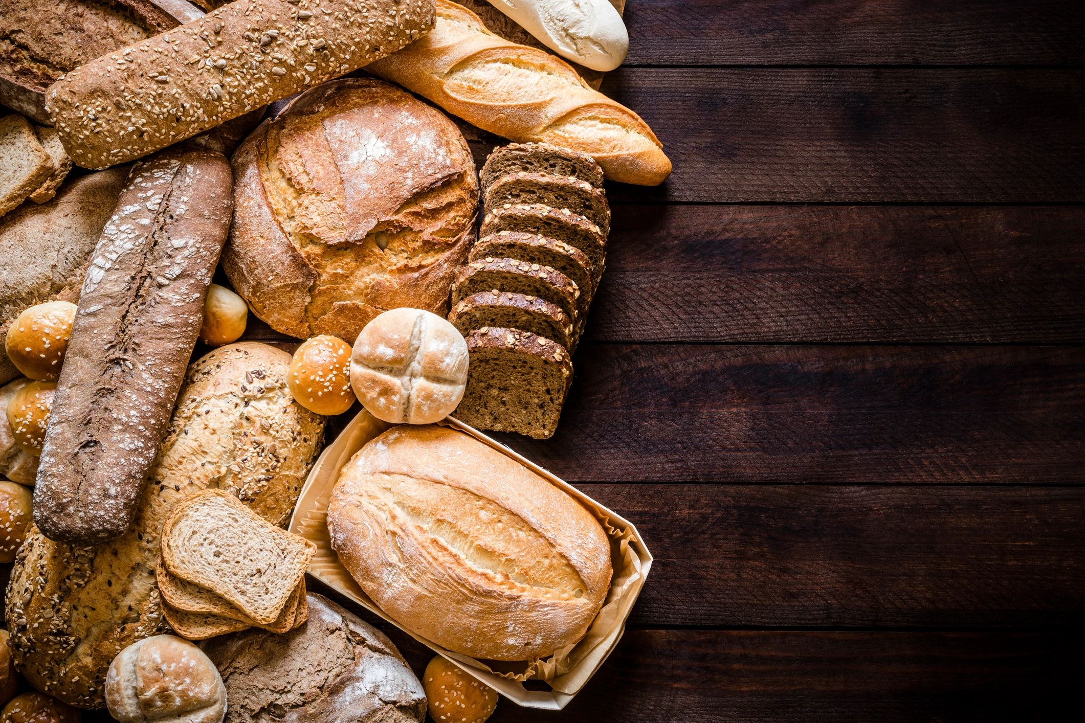 Assorted breads on a rustic wooden table