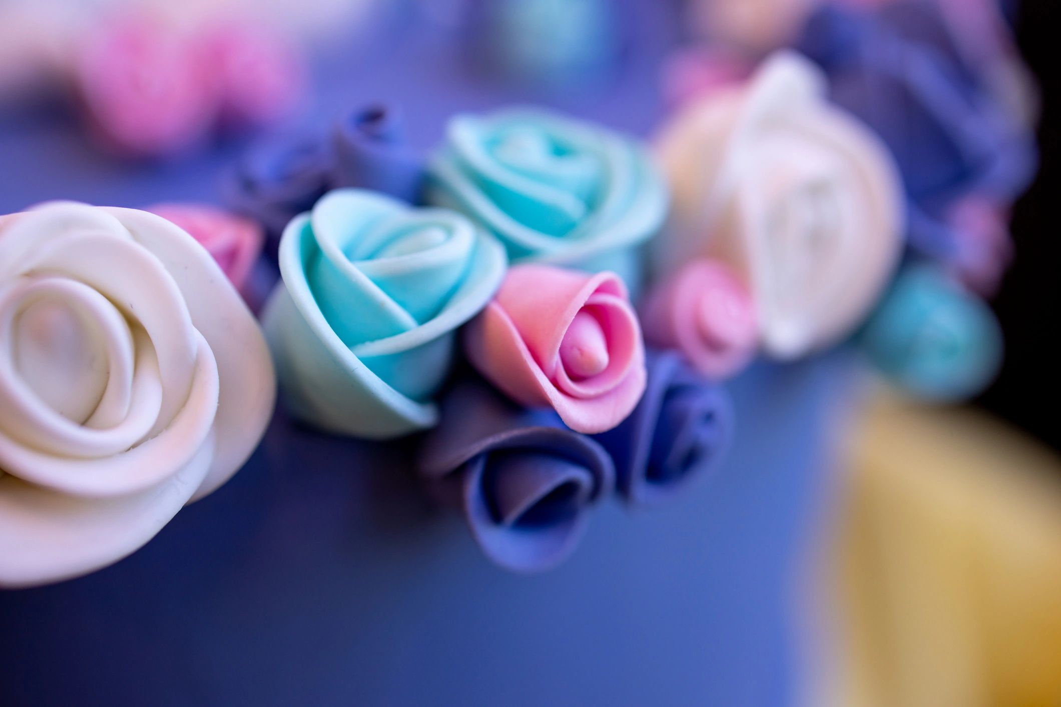 Sugar icing roses being added to a cake