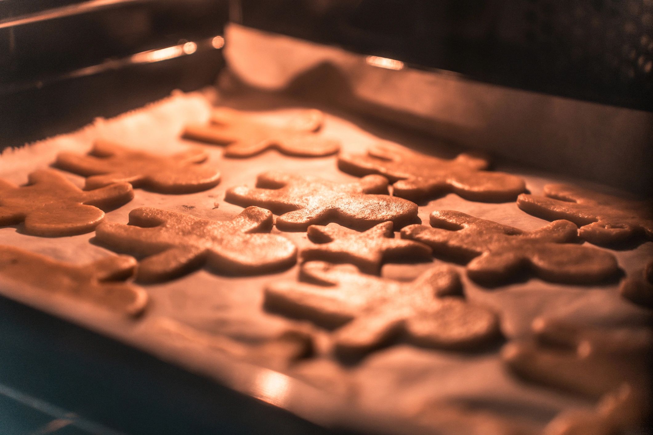 Cookies baking on a sheet in the oven