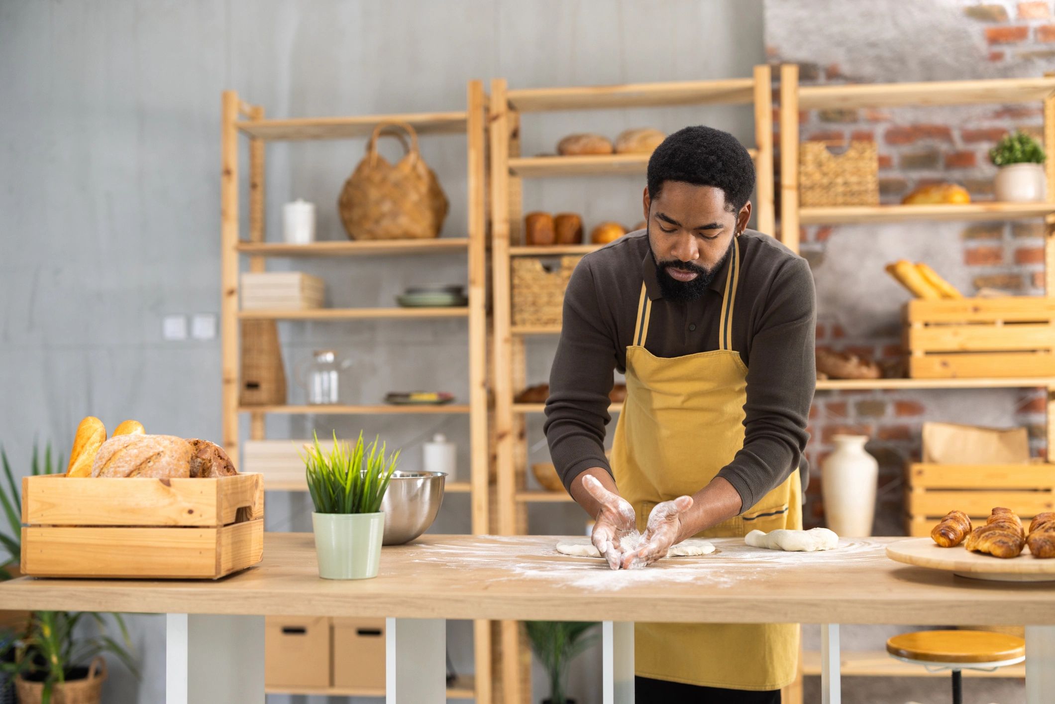 Baker preparing dough on a wooden table